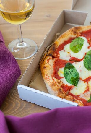 Pizza Margherita on black stone background. Homemade Pizza Margarita with Tomatoes, Basil and Mozzarella Cheese.の写真素材