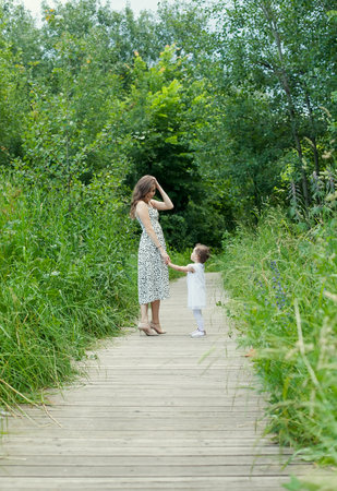 Mother and her kids walking in parkの写真素材