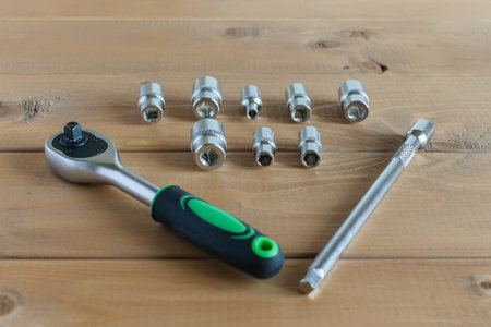 A multipurpose precision tool kit set box showing wrenches with different interchangeable bit head sizes arranged in rows to cater to varying types of screws, nuts and bolt types - closeup top view.の写真素材