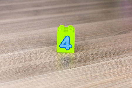 Toy blocks forming a cube with the number four isolated on white backgroundの写真素材
