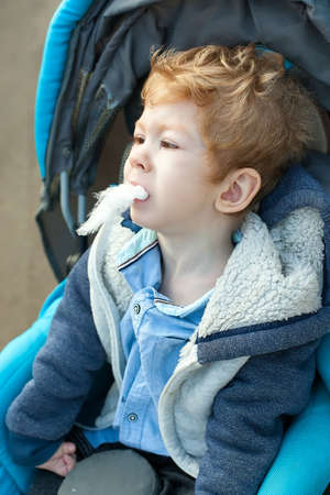 Disabled child on wheelchair waiting to eat ice cream in the cafe, Restaurant background, Special children's lifestyle, Life in the education age of special need children, Happy disability kid concept.の写真素材