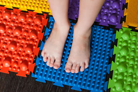 Foot massage mat for babies. Prevention of flat feet and hallux valgus. Orthopedic massage puzzle mats for the development of children.の写真素材