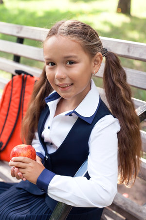backpack. Portrait of modern happy teen school girl with bag backpack. Girl with dental braces and glasses.の写真素材