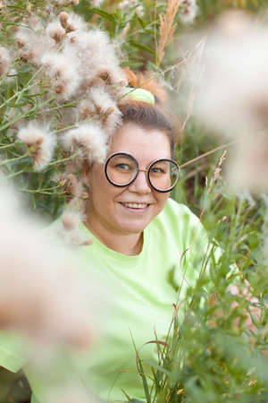 The girl leaves along the green alley at sunset on a summer evening. Model plus sizeの写真素材
