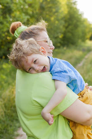 A mother gently hugs a disabled child. Infantile cerebral palsy. Enabling. Disability. A family with a disabled child.の写真素材