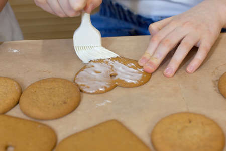 Homemade cookies with brown gingerbread for the holidays, covered with icing and decorated with...
