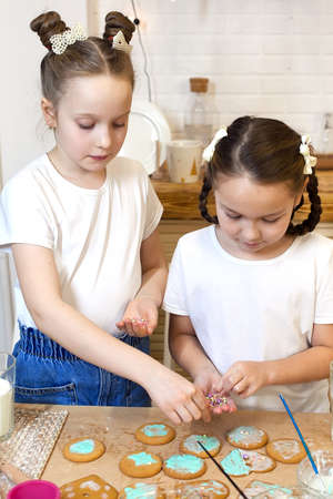 Christmas gingerbread and baking ingredients, decoration with icing and powdered sugar.
