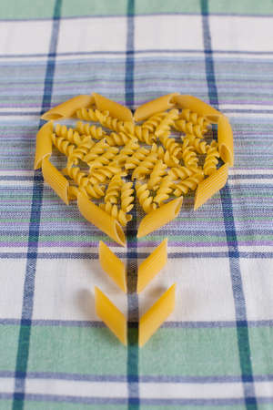 Raw pasta set, background with many different sorts of pasta and farfalle, closeupの写真素材