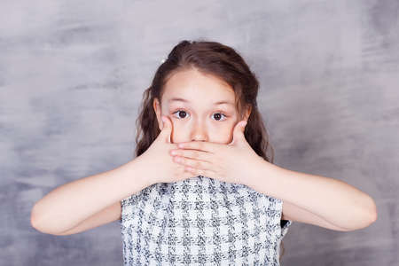 Laughing cute girl portrait at home. Little child smiling and looking at camera.の写真素材