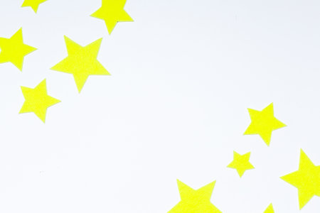 yellow stars made of felt on a white background. space day. space.の写真素材