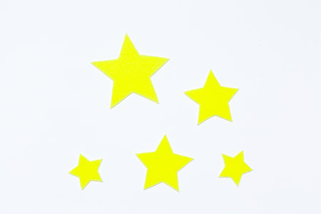 yellow stars made of felt on a white background. space day. space.