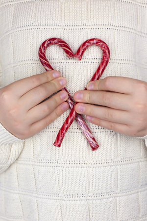 New Years flatley with lollipops on a stick on the background of a knitted sweaterの写真素材