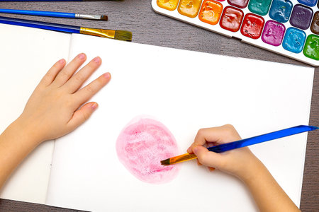 Cute little preschooler child drawing at homeの写真素材