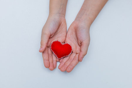 Frame from red felt hearts on white background. St. Valentines Day concept. Top view, copy space