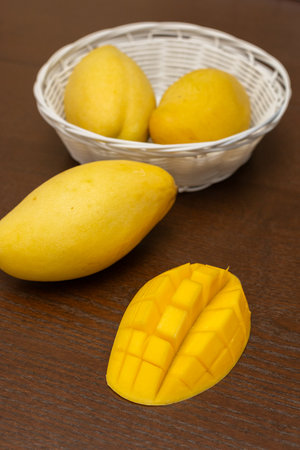 Delicious ripe juicy mangos on wooden table, top viewの写真素材