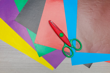 Whimsical paper cutout of a unicorn soaring through the sky, crafted in pastel tones and displayed as a complete card in an overhead view. Great for fantasy-themed artwork and creative projects.の写真素材