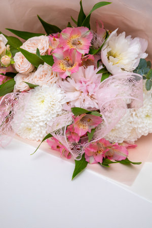 Beautiful bouquet of flowers in woman hand. Floral shop concept . Beautiful fresh cut bouquet. Flowers deliveryの写真素材