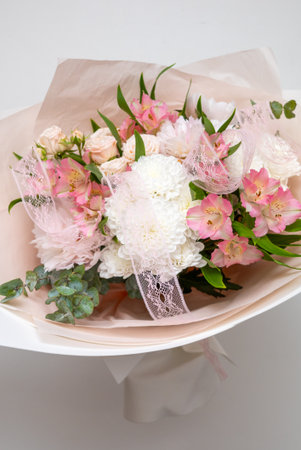 Beautiful bouquet of flowers in woman hand. Floral shop concept . Beautiful fresh cut bouquet. Flowers deliveryの写真素材