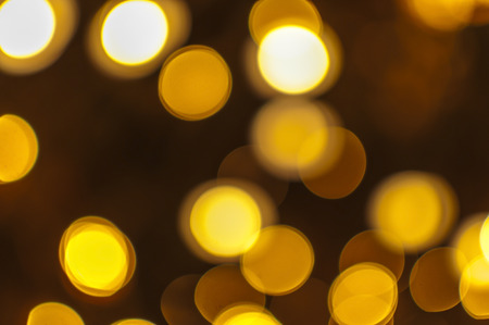 Gold color abstract Background with defocused and blurred lightsの写真素材
