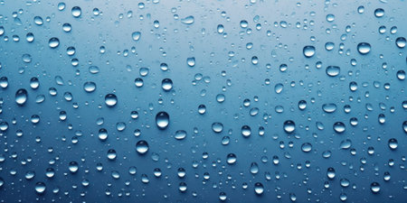 water drops on light blue background surfaceの写真素材