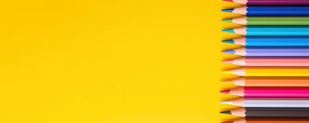 A group Colored pencils row on yellow backgroundの写真素材