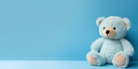 Cute teddy bear isolated on soft pastel background, with copy space for ads and textの素材