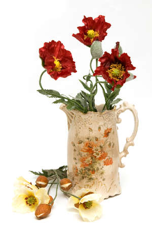 Isolated beautiful antique jug with poppy flowersの写真素材