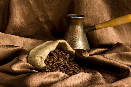 Still life with the turkey coffee maker and some raw coffee beansの写真素材