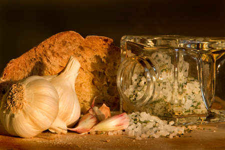 Evening still life with rye bread, garlic and salt.の写真素材