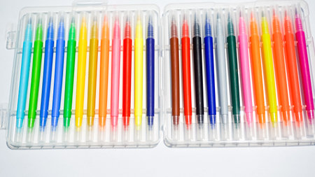 Colorful pens in plastic box isolated on white background. Top view.の写真素材