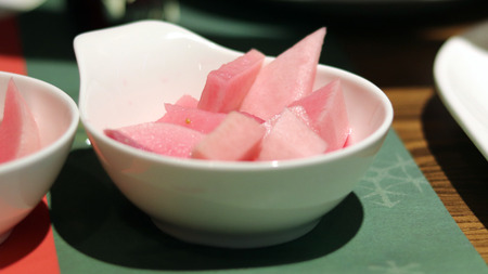 A plate of pink radish picklesの写真素材