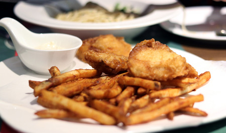 A plate of french fries and chickenの写真素材