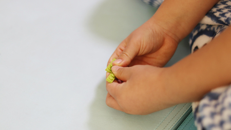 The hand blocks the toy blocks together.の写真素材