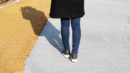 The back and shadow of a woman who takes a pictureの写真素材