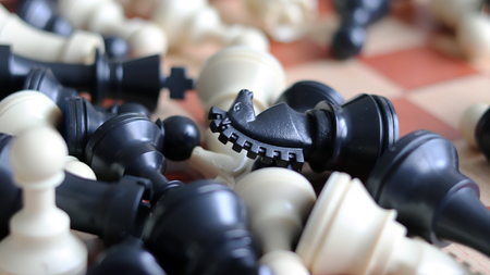 White pieces and black pieces of chess game. chess pieces with wood chessboard.の写真素材