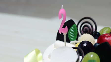 Number 2 candles on a cream cake.の写真素材
