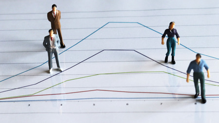 Miniature people. A miniature people standing on the graph.の写真素材