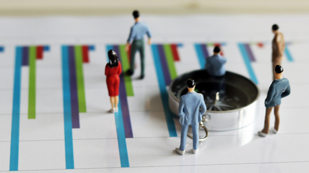 Appearance from behind compass and miniature people on the chart.の写真素材