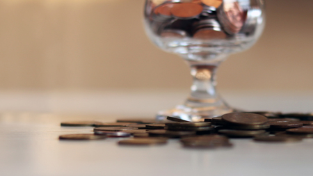 The concept of capital. The concept of coins and glass.