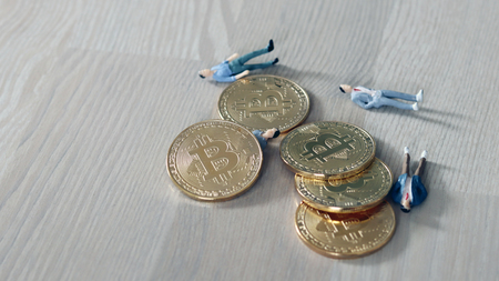 The relationship between bitcoin and danger. Bitcoin and miniature peopleの写真素材