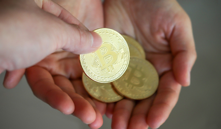 A finger trying to grab a coin on the palm of one's hand.の写真素材