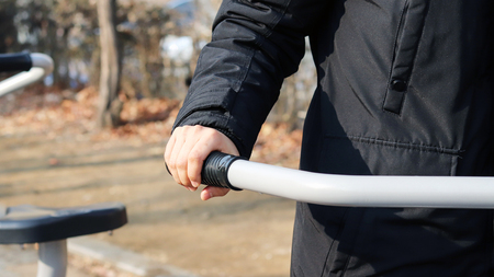 Exercise and health. Hands holding on to the grip of an exercise device