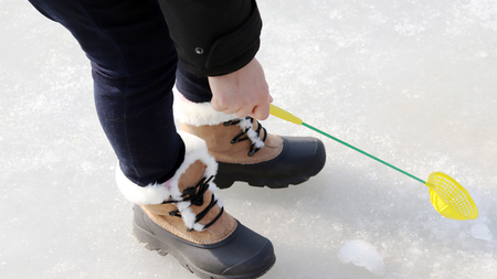 Ice fishing festival at the winter. scoop ice with an ice net
