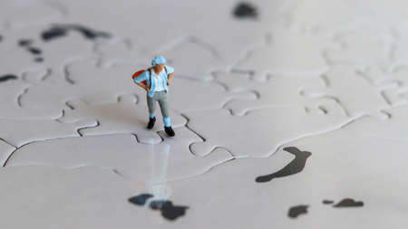 A miniature tourist on a world map by myself.