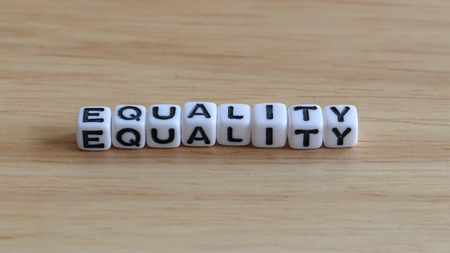 EQUALITY text cube on the wood background.の写真素材