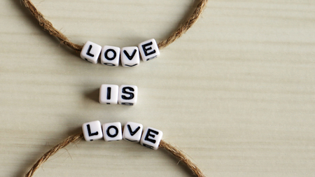 Thread an alphabet through a rope. LOVE IS LOVEの写真素材