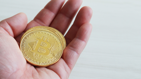 Bitcoin on the palm of the hand.