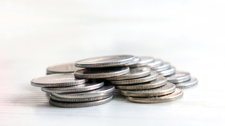 A pile of coins on the bright background.