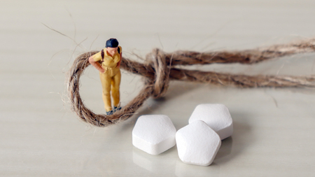 A miniature woman and drug.の写真素材