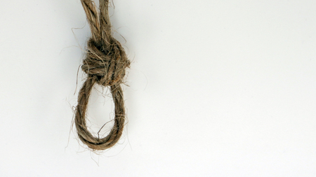 A rope tied with a knot in the wall.の写真素材